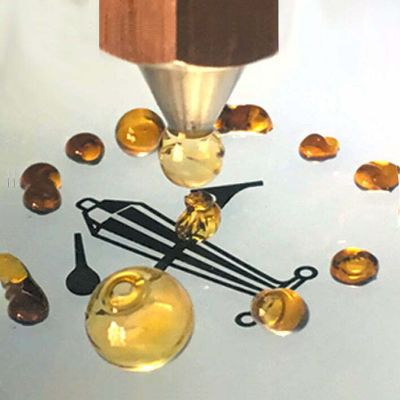 Golden amber rosin droplets extracted using the GEMSTX solventless hand press on a collection surface.